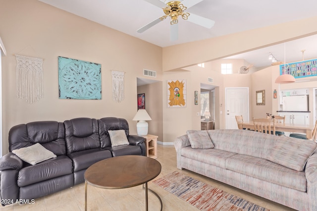 tiled living room with high vaulted ceiling and ceiling fan