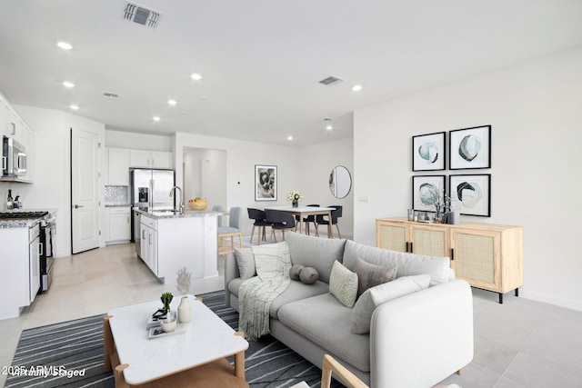 15611 W Hackamore Dr, Surprise, AZ 85387 - living room featuring recessed lighting and light tile patterned floors