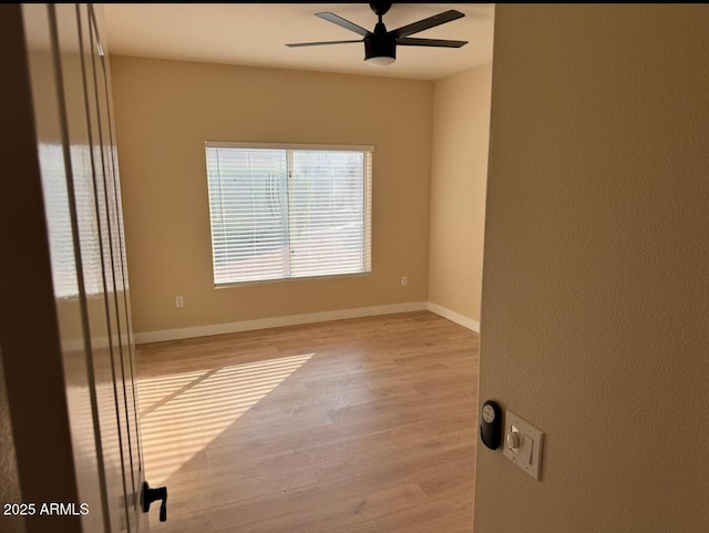 empty room featuring light wood-type flooring and ceiling fan