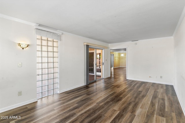 spare room with ornamental molding and dark hardwood / wood-style flooring