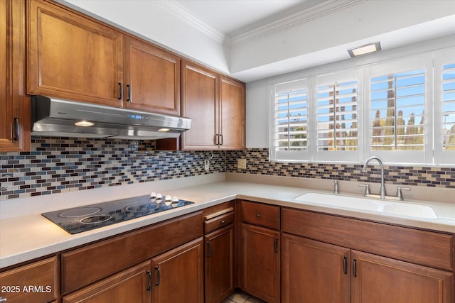 kitchen with crown molding, sink, backsplash, and black electric cooktop