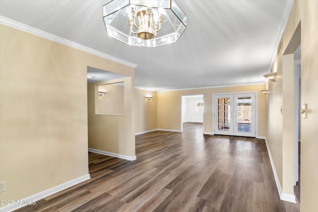 interior space with french doors, crown molding, a chandelier, and dark wood-type flooring