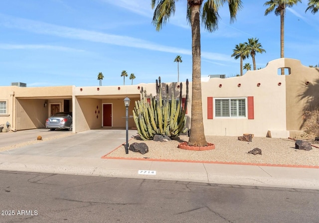 adobe home featuring a carport