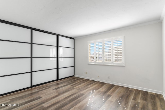 unfurnished room featuring crown molding and hardwood / wood-style floors