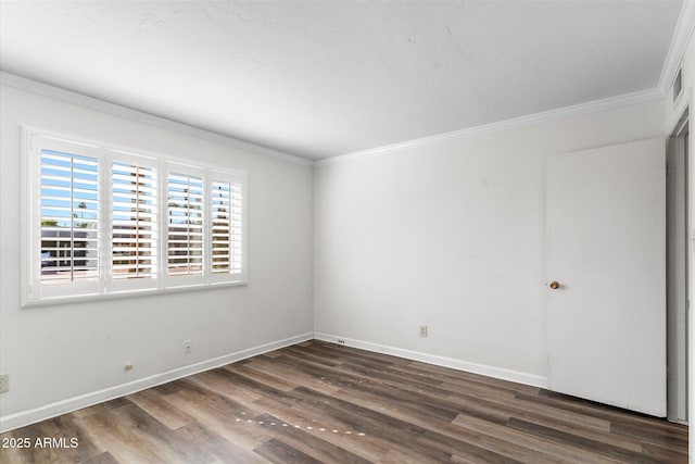 spare room with ornamental molding and dark wood-type flooring