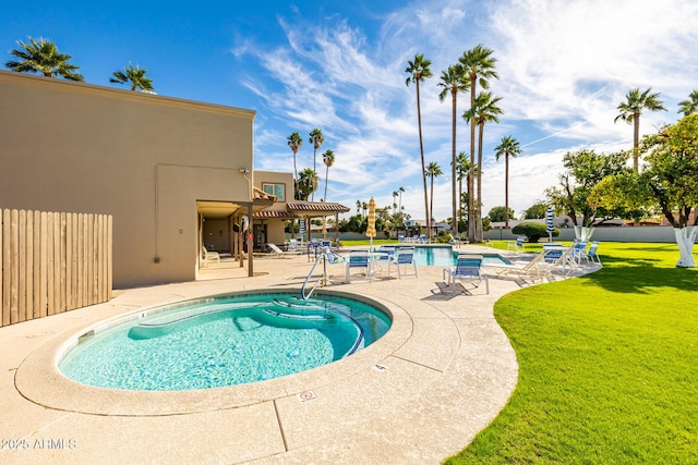 view of swimming pool featuring a yard, a pergola, and a patio