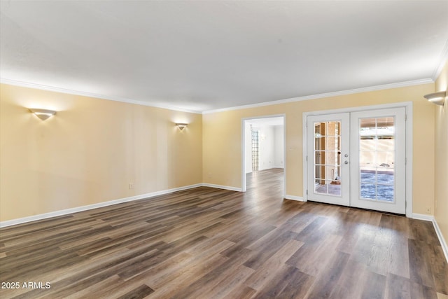 empty room featuring french doors, ornamental molding, and dark wood-type flooring