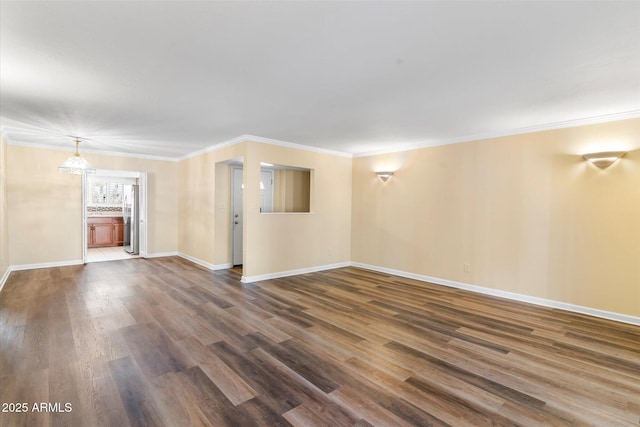 unfurnished living room featuring ornamental molding, dark wood-type flooring, and a notable chandelier