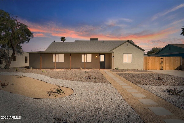 view of front of house featuring fence and stucco siding