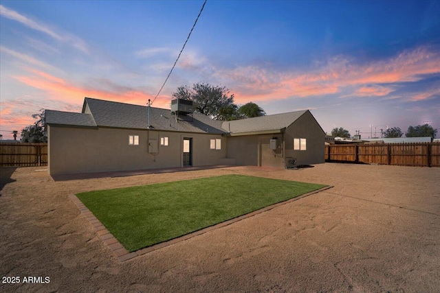 back of property featuring central air condition unit, a fenced backyard, and stucco siding