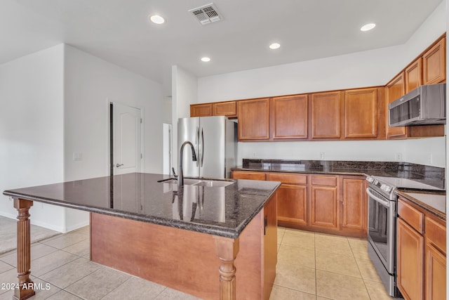 kitchen with light tile patterned floors, visible vents, appliances with stainless steel finishes, and a sink