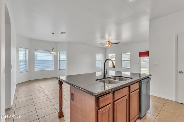 kitchen with visible vents, black dishwasher, light tile patterned floors, brown cabinetry, and a sink