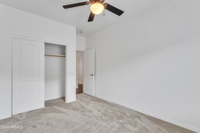 unfurnished bedroom with baseboards, a closet, carpet floors, and ceiling fan