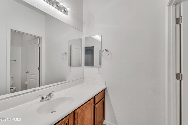 bathroom featuring toilet and vanity