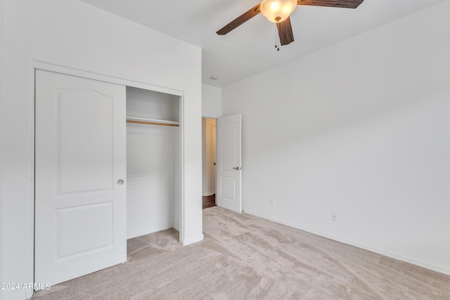 unfurnished bedroom featuring a closet, carpet flooring, and a ceiling fan