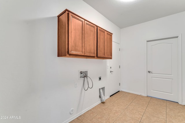 laundry area with light tile patterned floors, hookup for a washing machine, hookup for a gas dryer, cabinet space, and electric dryer hookup