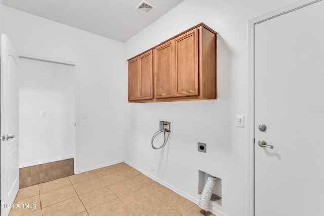 clothes washing area featuring hookup for a washing machine, visible vents, gas dryer hookup, cabinet space, and electric dryer hookup