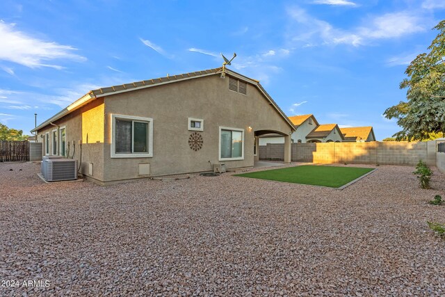 back of property with a patio area, central air condition unit, stucco siding, and a fenced backyard