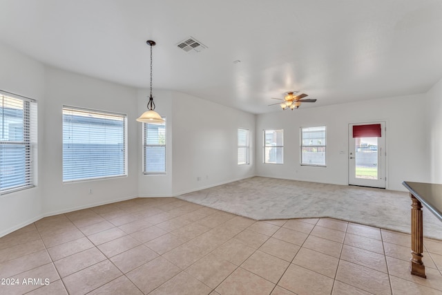 interior space featuring light carpet, visible vents, and light tile patterned floors