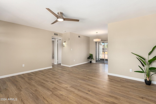 spare room featuring hardwood / wood-style floors and ceiling fan