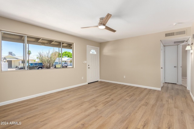 empty room featuring ceiling fan and light hardwood / wood-style floors