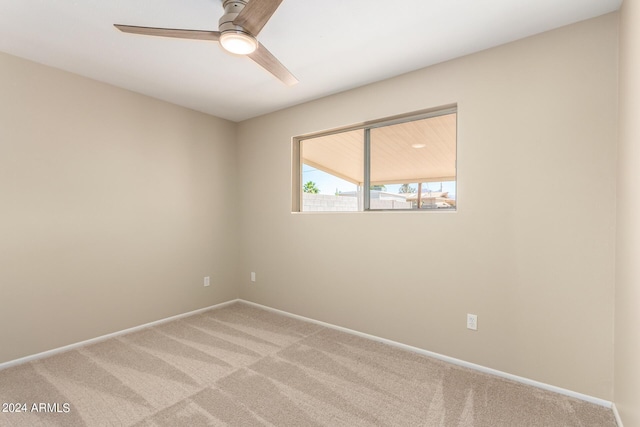 unfurnished room with ceiling fan and carpet floors