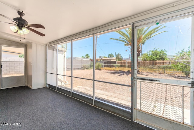 unfurnished sunroom with vaulted ceiling, plenty of natural light, and ceiling fan