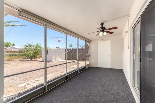 unfurnished sunroom featuring ceiling fan