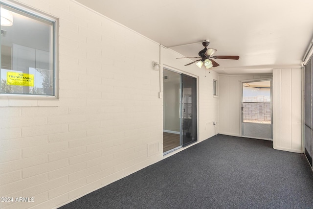 unfurnished sunroom featuring ceiling fan