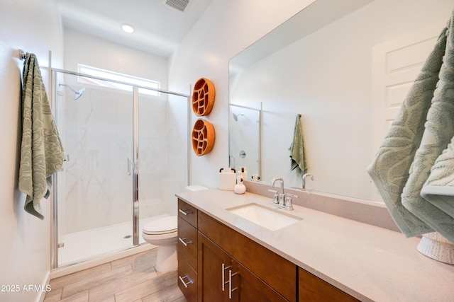 7854 W Tether Trl, Peoria, AZ 85383 - bathroom featuring toilet, a marble finish shower, vanity, and wood finished floors