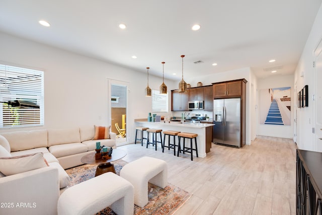 7854 W Tether Trl, Peoria, AZ 85383 - living area with light wood-style floors, recessed lighting, and stairway