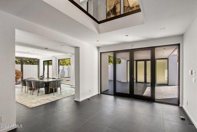interior space featuring french doors, baseboards, and a wealth of natural light