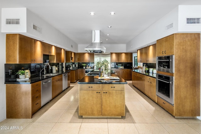 kitchen with light tile patterned floors, appliances with stainless steel finishes, a kitchen island, and island range hood