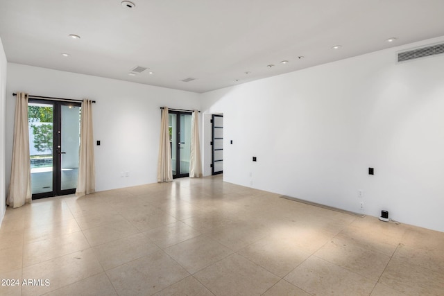 unfurnished room featuring french doors, light tile patterned floors, visible vents, and recessed lighting