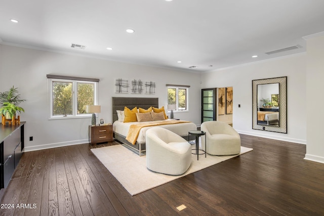 bedroom featuring crown molding, multiple windows, dark wood finished floors, and visible vents