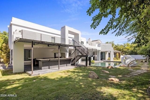 back of house with a patio, stucco siding, an outdoor pool, stairs, and a yard
