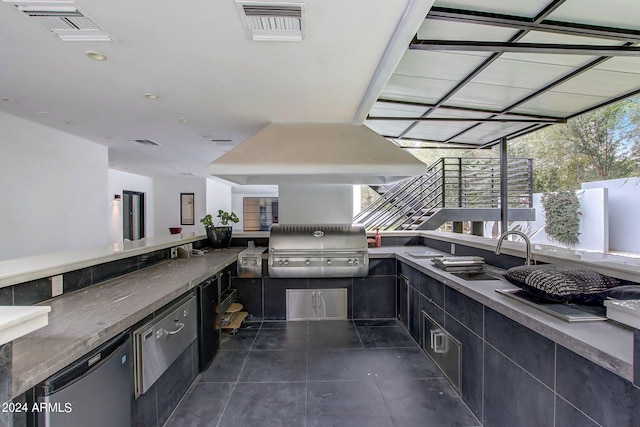 view of patio / terrace featuring grilling area, a sink, and visible vents