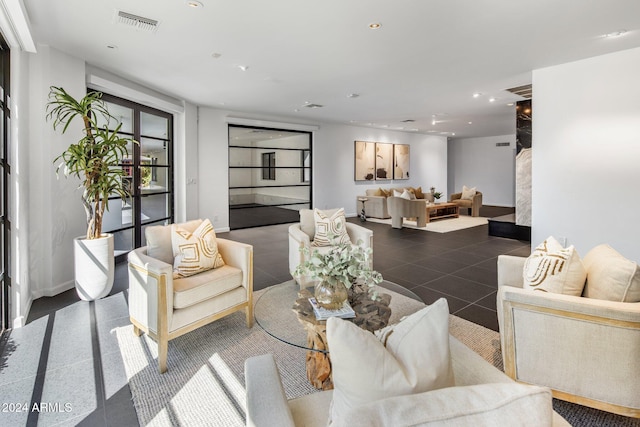living area with recessed lighting, visible vents, and baseboards