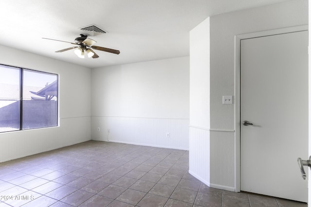 unfurnished room with tile patterned floors and ceiling fan