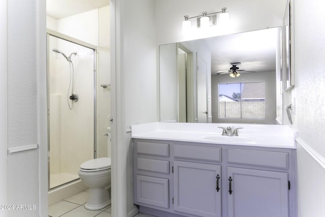 bathroom with vanity, tile patterned floors, ceiling fan, toilet, and a shower with shower door