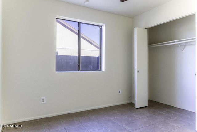 unfurnished bedroom featuring light tile patterned floors and a closet