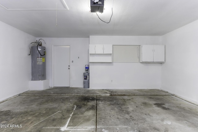 garage featuring electric water heater and a garage door opener