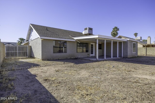 rear view of house with a patio and central air condition unit