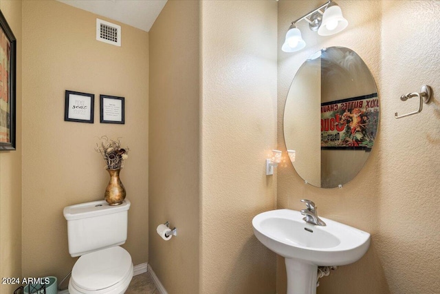 bathroom with toilet and sink