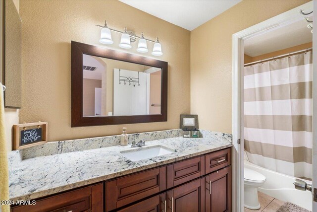 full bathroom featuring tile patterned flooring, vanity, toilet, and shower / tub combo