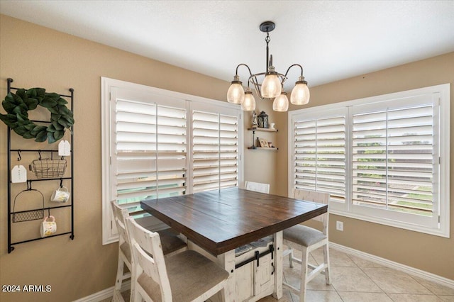 tiled dining area featuring a chandelier