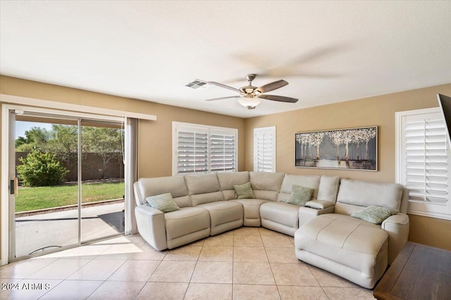 tiled living room with ceiling fan