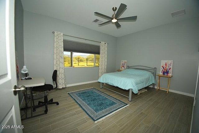 bedroom featuring baseboards, visible vents, ceiling fan, and wood finish floors