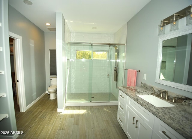 full bathroom with a stall shower, toilet, and wood tiled floor