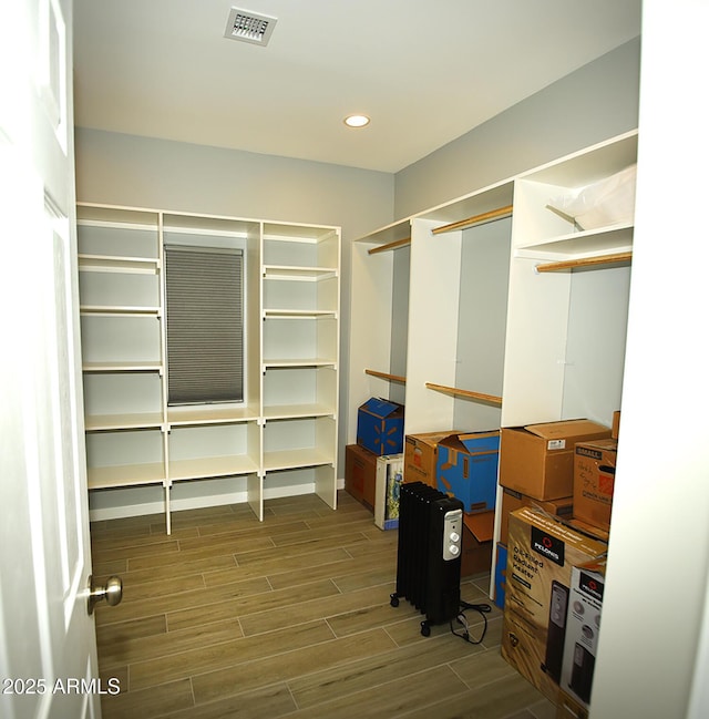 walk in closet with wood tiled floor and visible vents